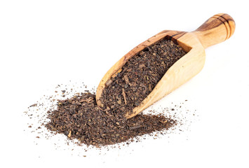 Dried Thai tea mixed with spices on wooden table and white isolated background