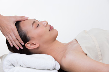 Obraz na płótnie Canvas Ayurvedic Head Massage Therapy on facial forehead Master Chakra Point of Asian woman, Therapist Spa body woman hands treatment on customer to increase circulation release tension stress of think work