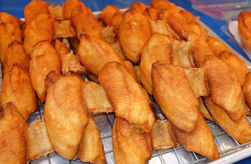 Sliced pieces of fried fish in street food market. Thailand.