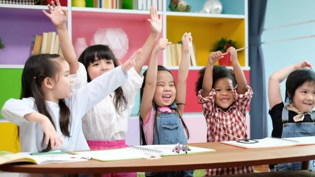 Group diversity kids studying at school, rising hands and enjoy in classroom, kids education concept