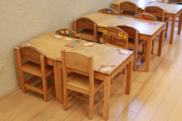 Small desk and chairs for kid in student classroom.