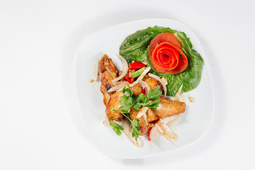 Traditional oriental cuisine of  Vietnam. Breaded Chicken Wings with green salad and tomato