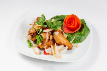 Traditional oriental cuisine of  Vietnam. Breaded Chicken Wings with green salad and tomato