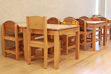 Small desk and chairs for kid in student classroom.