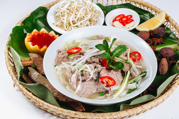 Traditional oriental cuisine of  Vietnam. Pho bo soup with rice noodles, beef, pepper, wheat germ, greens