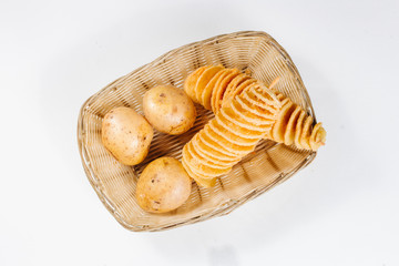  Potato chips on a stick in a basket of potatoes