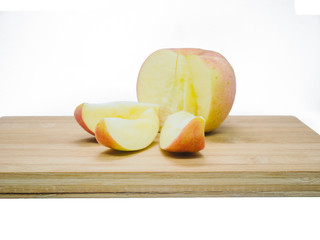 Apple was sliced on wooden board on isolate background