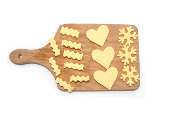cheese slices on cutting board. bow, snowflake heart shaped cut cheese