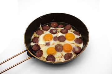 Turkish Sausage (sucuk) and egg. Turkish sausage and egg in pan on white background