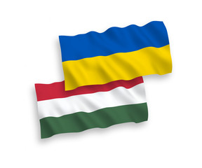 National vector fabric wave flags of Hungary and Ukraine isolated on white background. 1 to 2 proportion.