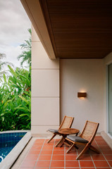 Old wooden coffee table and chair at outdoor balcony