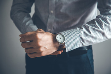 man hand watch on gray background