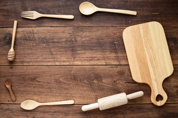 Different kind of wood utensils on wood background for cooking concept.