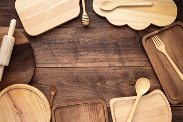 Different kind of wood utensils on wood background for cooking concept.