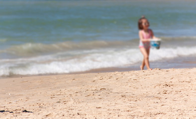 little girl at the water's edge as background