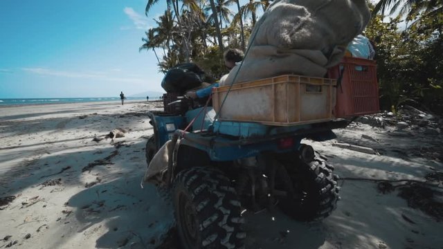 A four-wheeler with supplies on a white sandy beach