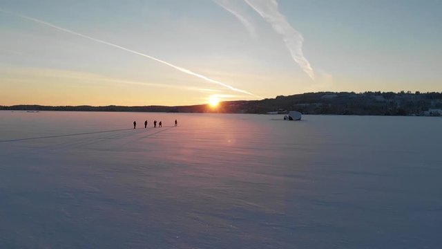 Cross-country Ski on a frozen Swedish lake in the sunset. Filmed with super slow motion and a drone.