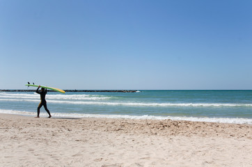 Sea landscape with silhouette of the passing surfer