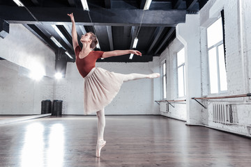 Beautiful good looking woman standing on her tiptoe