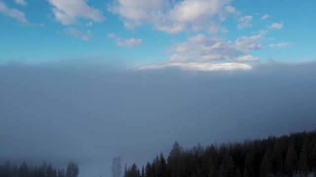 Reveals the mountain above the forest and fog, in Trysil,Norway