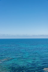 Fototapeta premium Clouds Over the Turquoise Waters of the Southern Mediterranean Sea on the Italian Coast