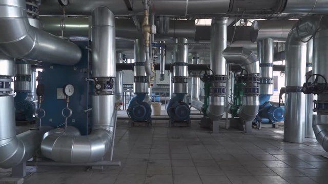 Greenhouse plant, view of pipes and pipelines of the heating and ventilation systems of greenhouses.