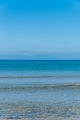 Fototapeta na wymiar Clear Turquoise Blue Water at a Southern Mediterranean Beach in Italy