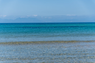 Fototapeta na wymiar Clear Turquoise Blue Water at a Southern Mediterranean Beach in Italy