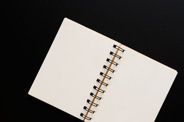 Design concept - Top view of empty kraft notebook on black background. mock up.