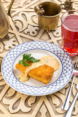 delicious golden batter deep fried fish fillets served on white plate on oriental table