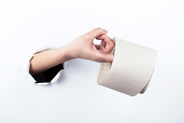 Female hand out of the hole in the paperman, holding a roll of toilet paper. Isolate on white background.