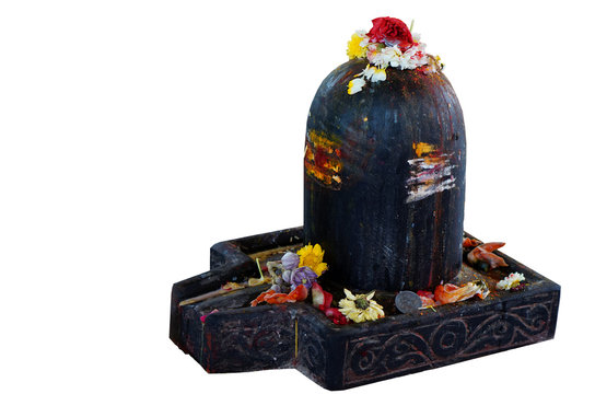 Hindu People offer prayers or do puja to stone  carved linga shape considered as God Shva on Maha shiva ratri ,a festival, in a temple, out doors