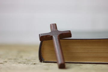 cross with a book on the table