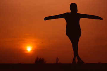 Fototapeta na wymiar Happy woman on the sunset in nature in summer with open hands - Image