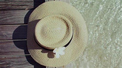 Still life with a hat On the background of clear blue sea water
