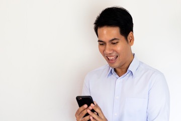 young Asian man looking smartphone with happiness