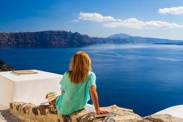 Luxury travel vacation woman looking at view on Santorini island