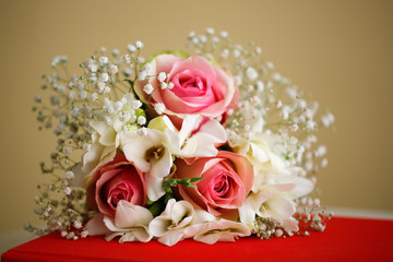 Beautiful wedding bouquet on red table