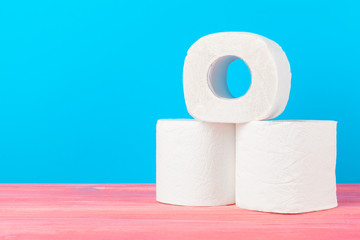 Toilet paper stack on bright blue background