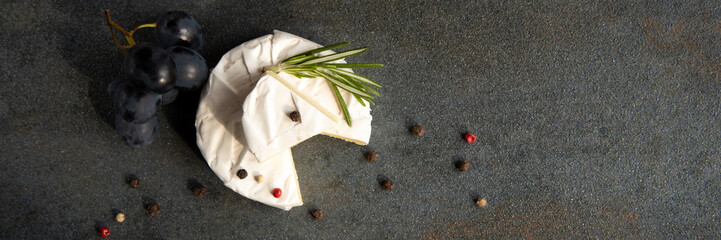 Cheese camembert or brie with dark grapes