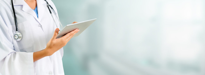 Doctor using tablet computer at the hospital. Medical healthcare and doctor staff service.