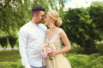 Portrait of wedding couple, stylish bride and groom in park