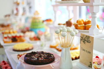 Candy bar with delicious sweets, chocolate candies, macaron tower and other