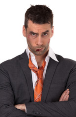 Close up of a businessman with bloody lip, beaten and bruised