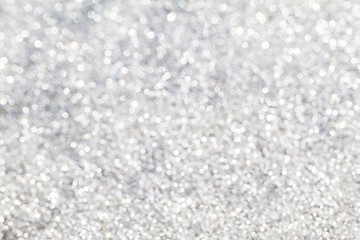 Blurred shiny white glitter bokeh abstract background