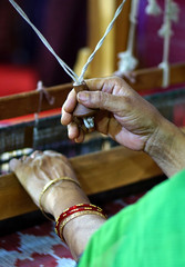View of Indian woman,weaving on wooden hand loom  machine