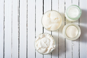 dairy product samples on white wood table background