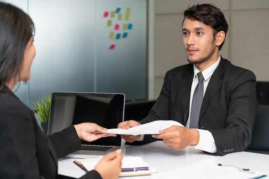 Human resource manager interviewing the male employment candidate in the office room. Happy job interview. Job application, recruitment and Asian labor hiring concept.