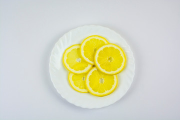 sliced lemons on a white plate