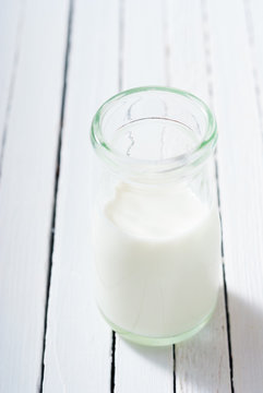 bottle of milk on white wood table